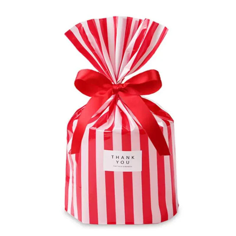 [gallery] Red candy-stripe flat-bottom gift bag cinched with a red ribbon