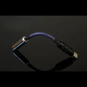 [detail] USB-C headphone DAC dongle arched on reflective black surface