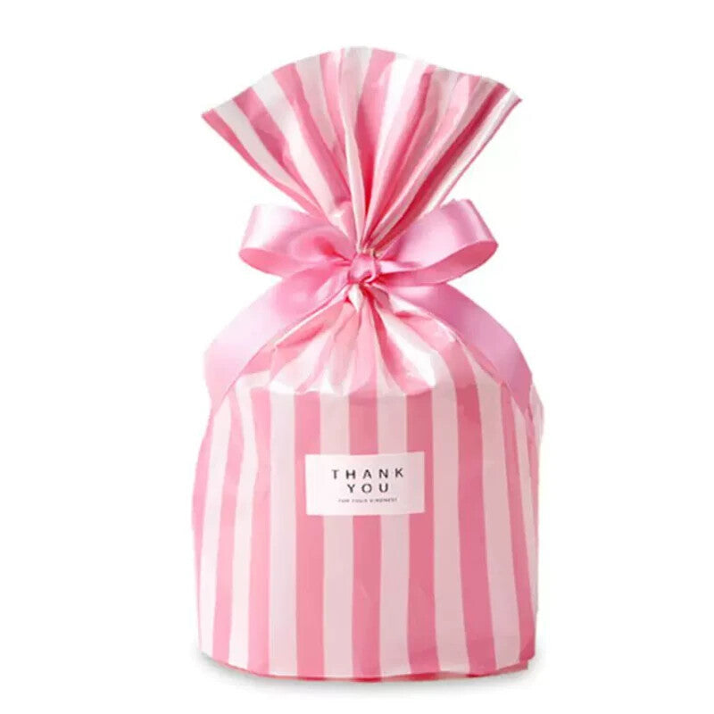 Blush pink candy-stripe flat-bottom gift bag cinched with a pink ribbon