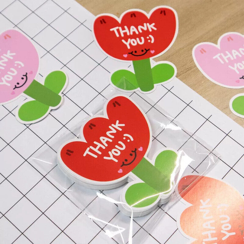 Red, pink, and yellow flower thank-you cards laid out