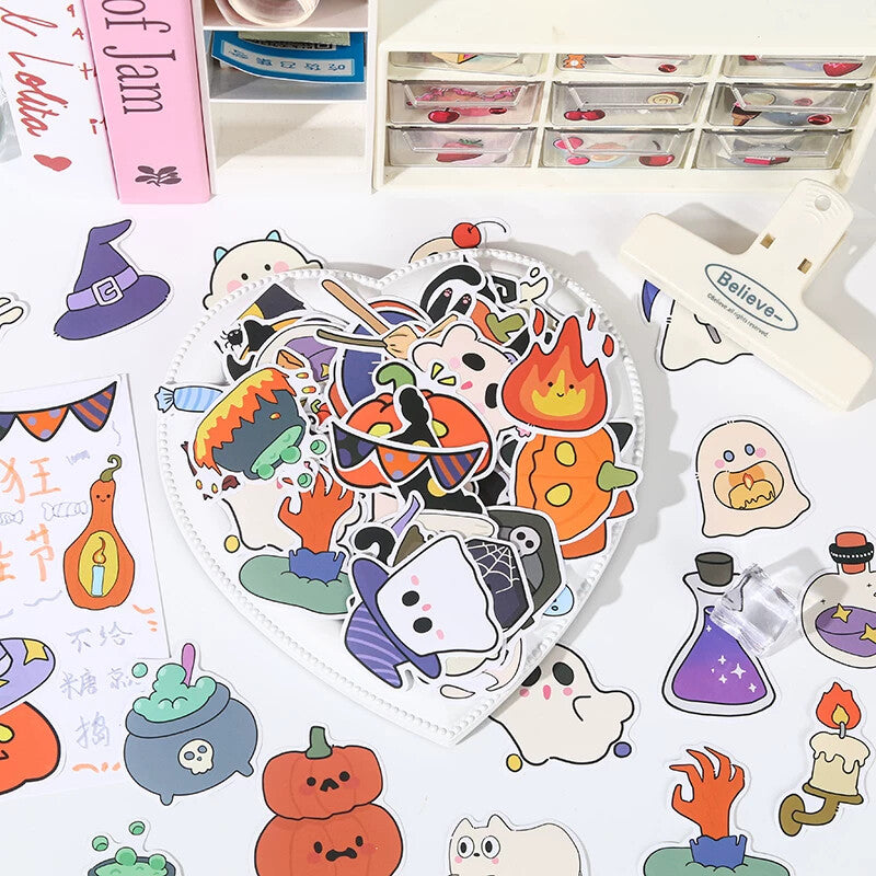 Desk flat lay of Halloween sticker sheets with planner tools