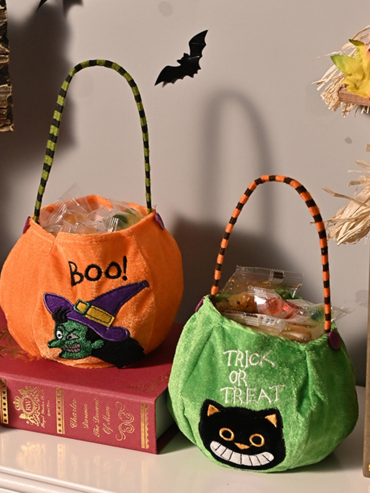 Halloween plush candy bags — close-up of bag openings with candy